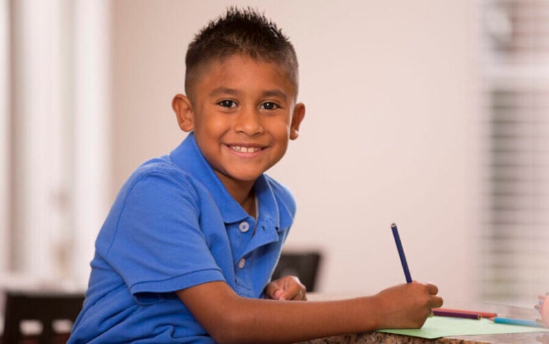 grade 3 student working on writing book report for class